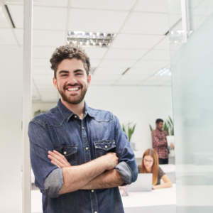 confident man posing against office wall